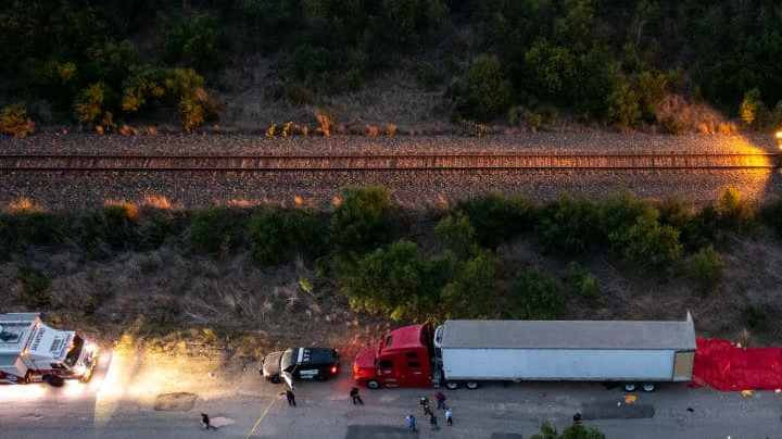 SAN ANTONIO, TX - JUNE 27: In this aerial view, members of law enforcement investigate a tractor trailer on June 27, 2022 in San Antonio, Texas. According to reports, at least 46 people, who are believed migrant workers from Mexico, were found dead in an abandoned tractor trailer. Over a dozen victims were found alive, suffering from heat stroke and taken to local hospitals. (Photo by Jordan Vonderhaar/Getty Images)