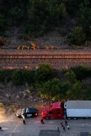 SAN ANTONIO, TX - JUNE 27: In this aerial view, members of law enforcement investigate a tractor trailer on June 27, 2022 in San Antonio, Texas. According to reports, at least 46 people, who are believed migrant workers from Mexico, were found dead in an abandoned tractor trailer. Over a dozen victims were found alive, suffering from heat stroke and taken to local hospitals. (Photo by Jordan Vonderhaar/Getty Images)