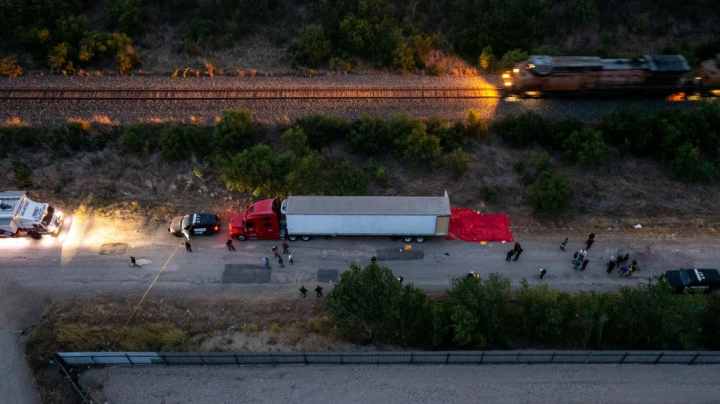 SAN ANTONIO, TX - JUNE 27: In this aerial view, members of law enforcement investigate a tractor trailer on June 27, 2022 in San Antonio, Texas. According to reports, at least 46 people, who are believed migrant workers from Mexico, were found dead in an abandoned tractor trailer. Over a dozen victims were found alive, suffering from heat stroke and taken to local hospitals. (Photo by Jordan Vonderhaar/Getty Images)