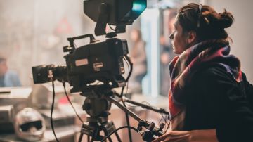 Behind the scene. Actor in front of the camera on the film set in film studio. Group movie scene