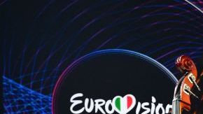 TOPSHOT - Members of the band "Kalush Orchestra" pose onstage with the winner's trophy and Ukraine's flags after winning on behalf of Ukraine the Eurovision Song contest 2022 on May 14, 2022 at the Pala Alpitour venue in Turin. (Photo by Marco BERTORELLO / AFP) (Photo by MARCO BERTORELLO/AFP via Getty Images)