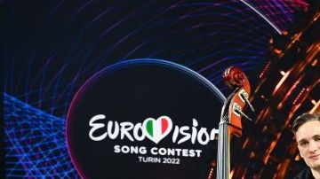 TOPSHOT - Members of the band "Kalush Orchestra" pose onstage with the winner's trophy and Ukraine's flags after winning on behalf of Ukraine the Eurovision Song contest 2022 on May 14, 2022 at the Pala Alpitour venue in Turin. (Photo by Marco BERTORELLO / AFP) (Photo by MARCO BERTORELLO/AFP via Getty Images)