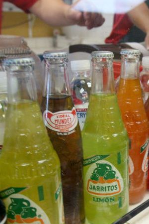 Bottled beverages are lined up for diners to choose from at Taqueria Los Gallos in Concord, Calif. on Tuesday, August 28, 2007.
PAUL CHINN/The Chronicle
Ran on: 09-06-2007
Diners, top, enjoy their meals at Taqueria Los Gallos in Concord, a restaurant specializing in seafood offerings. The ordering area, above, features bottles of beer, Mexican Pepsi and fruit sodas like Strawberry Crush and Jarritos in tamarind, pineapple and mandarin flavors.