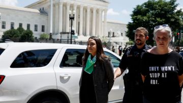 WASHINGTON, DC - JULY 19: Rep. Alexandria Ocasio-Cortez (D-NY) is detained by U.S. Capitol Police Officers after participating in a sit in with activists from Center for Popular Democracy Action (CPDA) in front of the U.S. Supreme Court Building on July 19, 2022 in Washington, DC. The CPDA held the protest with House Democrats in support of abortion rights. (Photo by Anna Moneymaker/Getty Images)