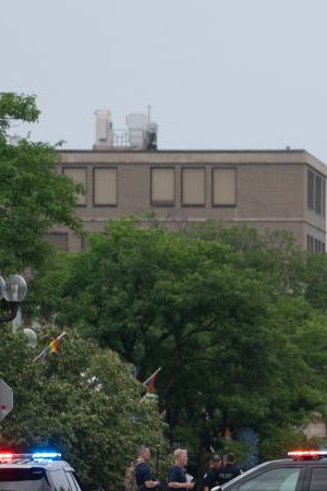Officers guard the scene of the Fourth of July parade shooting in Highland Park, Illinois on July 4, 2022. - A shooter opened fire Monday during a parade to mark US Independence Day in the state of Illinois, killing at least six people, officials said. "At this time, two dozen people have been transported to Highland Park hospital. Six are confirmed deceased," Commander Chris O'Neil of the city's police told journalists. The suspected shooter, who is still at large, has been described as a white male aged 18-20 with longer black hair, O'Neil said. (Photo by Youngrae Kim / AFP) (Photo by YOUNGRAE KIM/AFP via Getty Images)