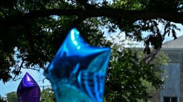 People visit a makeshift memorial to the victims of a shooting at Robb Elementary School outside the Uvalde County Courthouse in Uvalde, Texas, on June 30, 2022. - Nineteen young children and two teachers were killed when a teenage gunman went on a rampage at Robb Elementary on May 24 in America's worst school shooting in a decade. (Photo by CHANDAN KHANNA / AFP) (Photo by CHANDAN KHANNA/AFP via Getty Images)