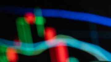 CHINA - 2021/12/09: In this photo illustration the American comic book publisher company DC Comics logo seen displayed on a smartphone with an economic stock exchange index graph in the background. (Photo Illustration by Budrul Chukrut/SOPA Images/LightRocket via Getty Images)