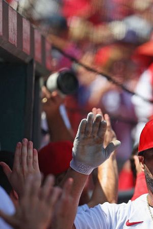 ST LOUIS, MO - AUGUST 18: Albert Pujols #5 of the St. Louis Cardinals his congratulated by teammates after hitting a grand slam against the Colorado Rockies in the third inning at Busch Stadium on August 18, 2022 in St Louis, Missouri. (Photo by Dilip Vishwanat/Getty Images)