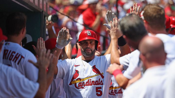 ST LOUIS, MO - AUGUST 18: Albert Pujols #5 of the St. Louis Cardinals his congratulated by teammates after hitting a grand slam against the Colorado Rockies in the third inning at Busch Stadium on August 18, 2022 in St Louis, Missouri. (Photo by Dilip Vishwanat/Getty Images)