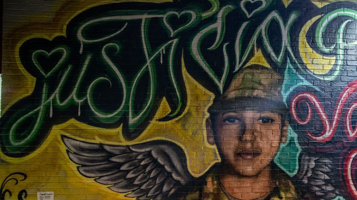 AUSTIN, TX - JULY 06: Flowers adorn a mural of Vanessa Guillen, a soldier based at nearby Fort Hood on July 6, 2020 in Austin, Texas. A suspect in the disappearance of Guillen, whose remains were found in a shallow grave, faced a judge Monday morning. (Photo by Sergio Flores/Getty Images)