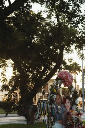 UVALDE, TX - JUNE 25: A couple from the nearby town of Del Rio, TX pays their respects at a memorial for the victims of the mass shooting at Robb Elementary School on June 25, 2022 in Uvalde, Texas. The Uvalde community is marking one month since the deadly shooting where 19 students and 2 teachers were killed. (Photo by Jordan Vonderhaar/Getty Images)