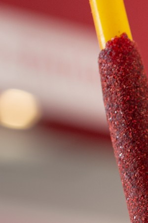 A view of a mangonada drink, in a restaurant interior setting.