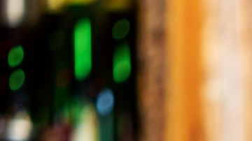 Assortment of alcoholic cocktails on a bar counter with gin and tonic, Moscow Mule, Asperol Spritz, Long Island Ice Tea, Sekt, Lillet Wild berry with fresh fruit ingredients in the foreground
