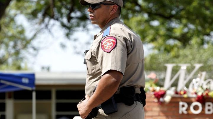 A police officer stands guard outside Robb Elementary School in the town of Uvalde, Texas, the United States, May 27, 2022. At least 19 children and two adults were killed in a shooting at Robb Elementary School in the town of Uvalde, Texas, on Tuesday. (Photo by Wu Xiaoling/Xinhua via Getty Images)