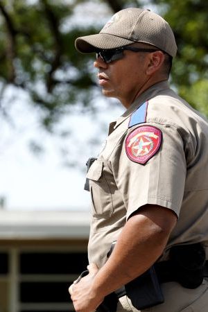 A police officer stands guard outside Robb Elementary School in the town of Uvalde, Texas, the United States, May 27, 2022. At least 19 children and two adults were killed in a shooting at Robb Elementary School in the town of Uvalde, Texas, on Tuesday. (Photo by Wu Xiaoling/Xinhua via Getty Images)