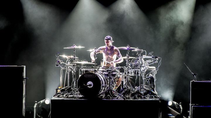 LONDON, UNITED KINGDOM - AUGUST 06: Travis Barker of Blink 182 performs on stage during their Reading Leeds Festival warmup show at Brixton Academy on August 6, 2014 in London, United Kingdom. (Photo by Ollie Millington/Redferns via Getty Images)