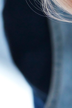 Girl and her sister baking a cake, decorating cake with fresh cream and raspberries at kitchen table, cropped - stock photo