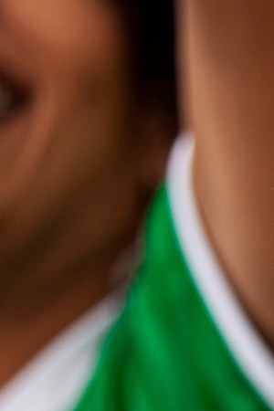 Front view portrait of Mexican football wearing Lucha Libre wrestling mask while watching international championship match at stadium