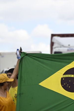 BRASILIA, BRAZIL - NOV 01 - Supporters of Brazil's President Jair Bolsonaro react, as they block highway BR-251 during a protest against President-elect Luiz Inacio Lula da Silva who won a third term following the presidential election run-off, in Planaltina, Brazil, November 1, 2022. (Photo by Mateus Bonomi/Anadolu Agency via Getty Images)