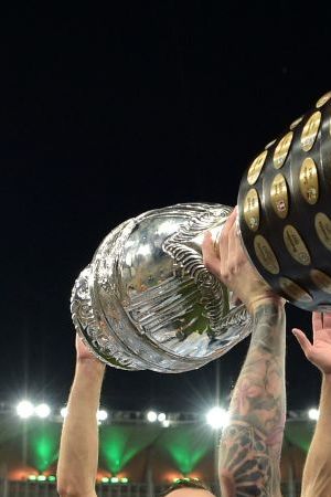 TOPSHOT - Argentina's Lionel Messi holds the trophy as he celebrates with teammates after winning the Conmebol 2021 Copa America football tournament final match against Brazil at Maracana Stadium in Rio de Janeiro, Brazil, on July 10, 2021. - Argentina won 1-0. (Photo by CARL DE SOUZA / AFP) (Photo by CARL DE SOUZA/AFP via Getty Images)