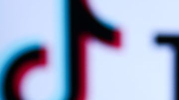 TikTok logo displayed on a phone screen and TikTok logo displayed on a laptop screen are seen in this illustration photo taken in Krakow, Poland on November 5, 2022. (Photo by Jakub Porzycki/NurPhoto via Getty Images)
