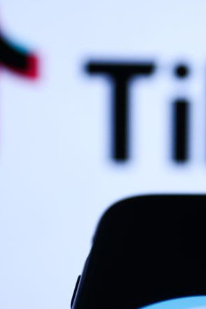 TikTok logo displayed on a phone screen and TikTok logo displayed on a laptop screen are seen in this illustration photo taken in Krakow, Poland on November 5, 2022. (Photo by Jakub Porzycki/NurPhoto via Getty Images)