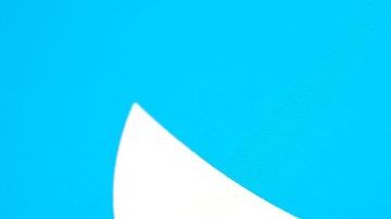 This illustration photo taken May 13, 2022, displays Elon Musks Twitter account with a Twitter logo in the background in Los Angeles. - Elon Musk sent mixed messages Friday about his proposed Twitter acquisition, pressuring shares of the microblogging platform amid skepticism on whether the deal will close. In an early morning tweet, Musk said the $44 billion takeover was "temporarily on hold," pending questions over the social media company's estimates of the number of fake accounts or "bots." That sent Twitter's stock plunging 25 percent. (Photo by Chris DELMAS / AFP) (Photo by CHRIS DELMAS/AFP via Getty Images)