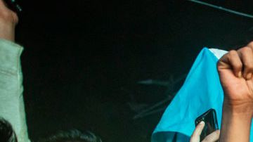 Football fans in Bangladesh celebrate after Argentina players scored a goal as they watch the Qatar 2022 World Cup Group C football match between Argentina and Poland on a big screen, the Dhaka University area, on December 1, 2022.