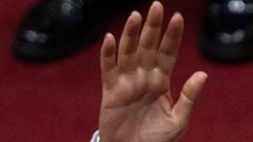 Peruvian Dina Boluarte greets members of the Congress after being sworn in as the new President hours after former President Pedro Castillo was impeached in Lima, on December 7, 2022. - Peru's Pedro Castillo was impeached and replaced as president by his deputy on Wednesday in a dizzying series of events in the country that has long been prone to political upheaval. Dina Boluarte, a 60-year-old lawyer, was sworn in as Peru's first female president just hours after Castillo tried to wrest control of the legislature in a move criticised as an attempted coup. (Photo by Cris BOURONCLE / AFP) (Photo by CRIS BOURONCLE/AFP via Getty Images)