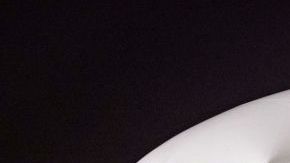 Members of the Argentinian team peer out from the windows on their plane adorned with a picture of Argentina's forward Lionel Messi and teammates as the team arrives at the Hamad International Airport in Doha on November 17, 2022, ahead of the Qatar 2022 World Cup football tournament. (Photo by Odd ANDERSEN / AFP) (Photo by ODD ANDERSEN/AFP via Getty Images)