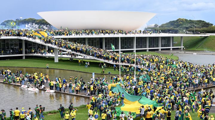 Supporters of Brazilian former President Jair Bolsonaro hold a demonstration at the Esplanada dos Ministerios in Brasilia on January 8, 2023. - Brazilian police used tear gas Sunday to repel hundreds of supporters of far-right ex-president Jair Bolsonaro after they stormed onto Congress grounds one week after President Luis Inacio Lula da Silva's inauguration, an AFP photographer witnessed. (Photo by EVARISTO SA / AFP) (Photo by EVARISTO SA/AFP via Getty Images)