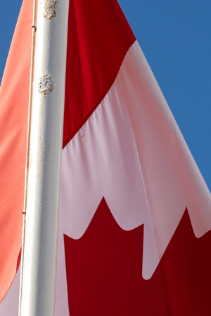 Flags of United States, Mexico, Canada flying together, concept of new NAFTA trade agreement now known as USMCA in the USA, CUSMA in Canada or T-MEC in Mexico.