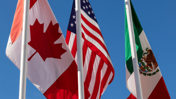 Flags of United States, Mexico, Canada flying together, concept of new NAFTA trade agreement now known as USMCA in the USA, CUSMA in Canada or T-MEC in Mexico.