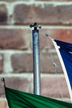 Mexican and American flag with wall behind