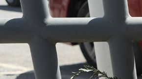 An activist lays a floral offering on a makeshift altar during a protest outside an immigration detention center in Ciudad Juarez, Chihuahua state, Mexico, on March 28, 2023. (Photo by HERIKA MARTINEZ / AFP) (Photo by HERIKA MARTINEZ/AFP via Getty Images)