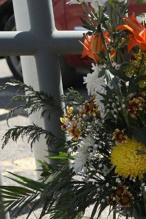 An activist lays a floral offering on a makeshift altar during a protest outside an immigration detention center in Ciudad Juarez, Chihuahua state, Mexico, on March 28, 2023. (Photo by HERIKA MARTINEZ / AFP) (Photo by HERIKA MARTINEZ/AFP via Getty Images)
