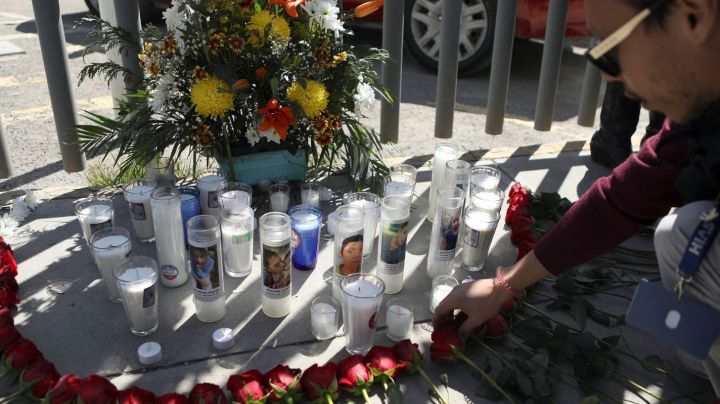 An activist lays a floral offering on a makeshift altar during a protest outside an immigration detention center in Ciudad Juarez, Chihuahua state, Mexico, on March 28, 2023. (Photo by HERIKA MARTINEZ / AFP) (Photo by HERIKA MARTINEZ/AFP via Getty Images)