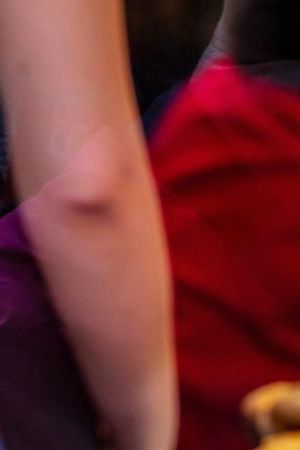 Pizzeria glass window. Variety of italian pizzas in a shop display, street food. Kitchen workers arranging the pizzas.