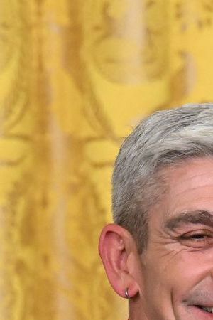 US President Joe Biden awards poet Richard Blanco with the 2021 National Humanities Medal during a ceremony in the East Room of the White House in Washington, DC, March 21, 2023. (Photo by SAUL LOEB / AFP) (Photo by SAUL LOEB/AFP via Getty Images)