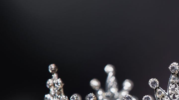 Diamond Silver Crown for Miss Pageant Beauty Contest, Crystal Tiara jewelry decorated gems stone and abstract dark background on black velvet fabric cloth, Macro photography copy space for text logo
