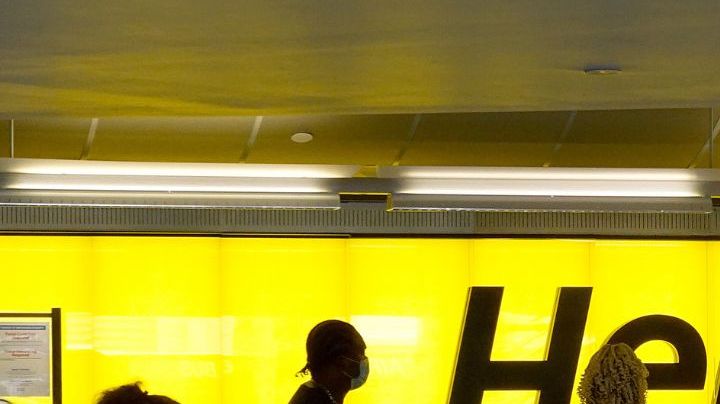 FORT LAUDERDALE, FLORIDA - OCTOBER 25: People stand at a Hertz car rental counter in the Fort Lauderdale-Hollywood International Airport on October 25, 2021 in Miami, Florida. Hertz announced that it ordered 100,000 Teslas as the company is emerging from bankruptcy. (Photo by Joe Raedle/Getty Images)
