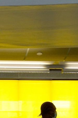 FORT LAUDERDALE, FLORIDA - OCTOBER 25: People stand at a Hertz car rental counter in the Fort Lauderdale-Hollywood International Airport on October 25, 2021 in Miami, Florida. Hertz announced that it ordered 100,000 Teslas as the company is emerging from bankruptcy. (Photo by Joe Raedle/Getty Images)