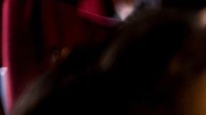 Girl and guy watching a horror movie at the cinema.