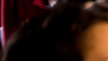 Girl and guy watching a horror movie at the cinema.