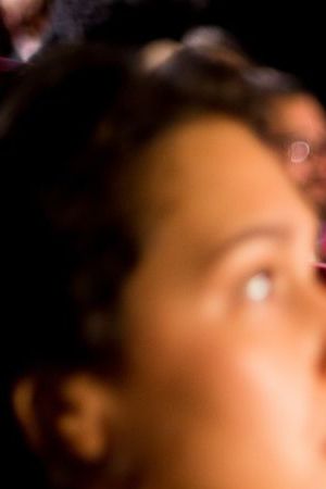 Girl and guy watching a horror movie at the cinema.