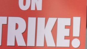 LOS ANGELES, CA - MAY 02: People picket outside of Paramount Pictures on the first day of the Hollywood writers strike on May 2, 2023 in Los Angeles. Scripted TV series, late-night talk shows, film and streaming productions are being interrupted by the Writers Guild of America (WGA) strike. In 2007 and 2008, a WGA strike shut down Hollywood productions for 100 days, costing the local economy between $2 billion and $3 billion. (Photo by David McNew/Getty Images)