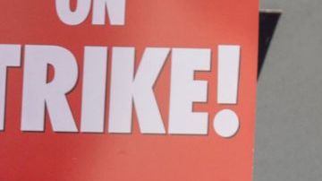 LOS ANGELES, CA - MAY 02: People picket outside of Paramount Pictures on the first day of the Hollywood writers strike on May 2, 2023 in Los Angeles. Scripted TV series, late-night talk shows, film and streaming productions are being interrupted by the Writers Guild of America (WGA) strike. In 2007 and 2008, a WGA strike shut down Hollywood productions for 100 days, costing the local economy between $2 billion and $3 billion. (Photo by David McNew/Getty Images)