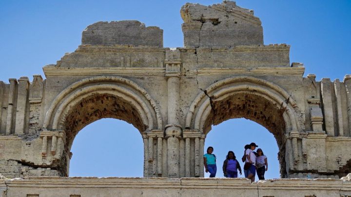 People visit the Temple of Quechula church that emerged from the Malpaso Dam due to a drought that dried up the Grijalba River in Nuevo Quechula, Chiapas, on June 16, 2023. The 16th-century Dominican church has been uncovered by the drought and high temperatures that plague the country. The construction had been almost completely submerged when the dam was built in the area in the 1960s on a tributary of the Grijalva River. Since then, tourists have been arriving by boat to visit it. However, the low level of the dam due to high temperatures, which left eight people dead in Mexico in the last week, meant that the construction was completely exposed, and now visitors arrive at its gates in their cars and motorcycles. (Photo by Raul VERA / AFP) (Photo by RAUL VERA/AFP via Getty Images)
