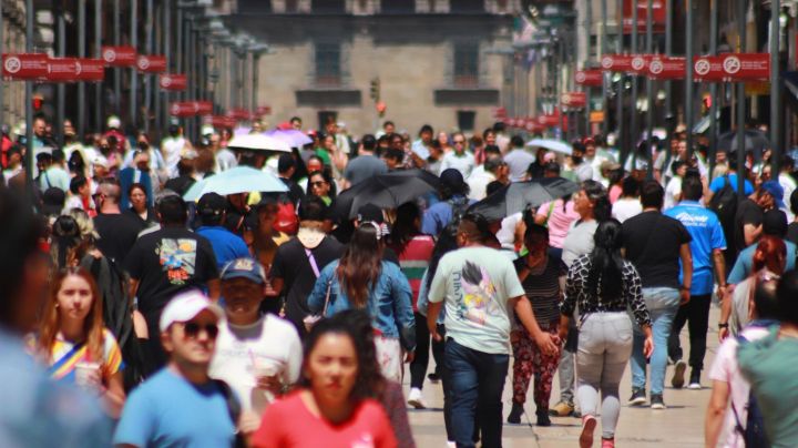 June 22, 2023 in Mexico City, Mexico: People protect themselves from the sun with umbrellas and quench their thirst with ice cream as they walk through the historic center, during the Orange Alert due to forecast high temperatures. (Photo credit should read Carlos Santiago / Eyepix Group/Future Publishing via Getty Images)