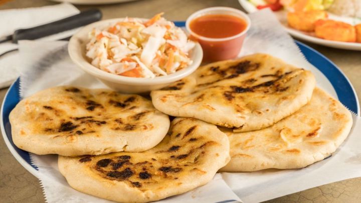 A dish of pupusas and others mexican food on the table - stock photo